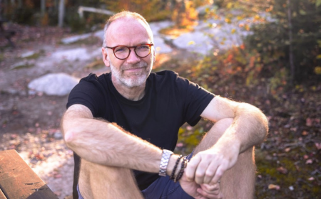 UCD alumnus Andrew Burton Anderson sitting outside.